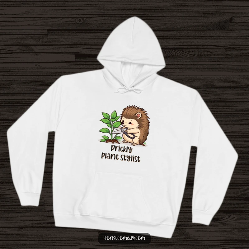 Funny hedgehog hoodie featuring a determined hedgehog trimming a leafy plant with pruning shears, perfect for cozy days and funny gardening vibes.