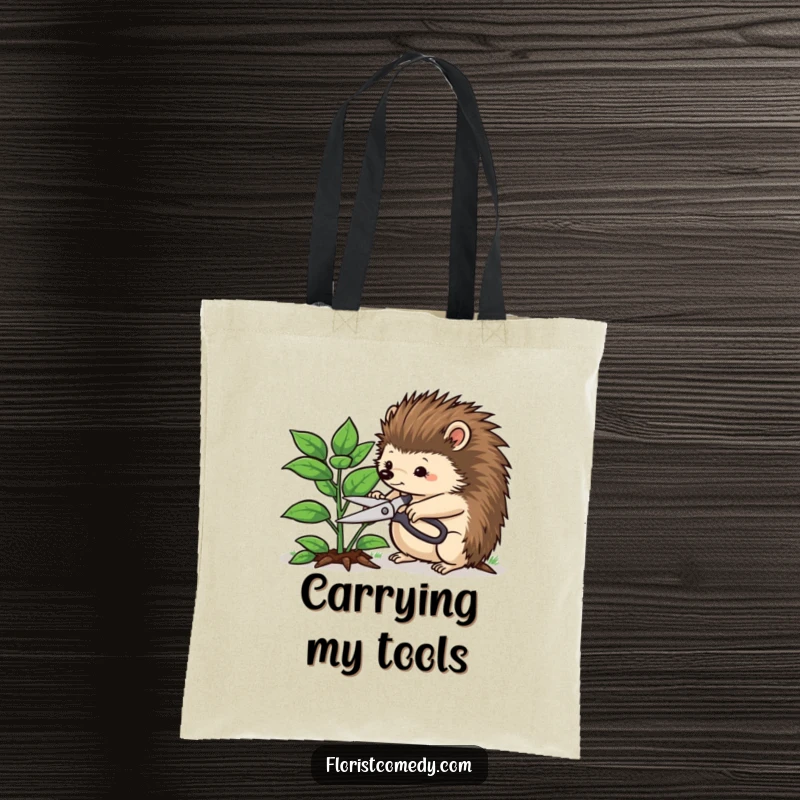 Funny hedgehog tote bag showing a determined hedgehog trimming a leafy plant, a humorous and practical accessory for garden enthusiasts.